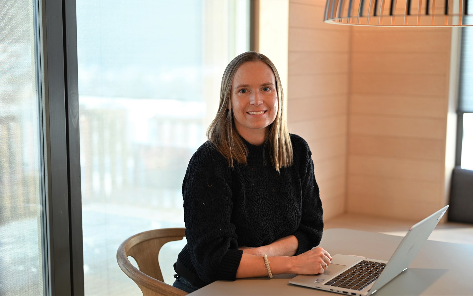 Woman at home office sitting by table in dining room. Dr. Marit Tuv, photo private. 